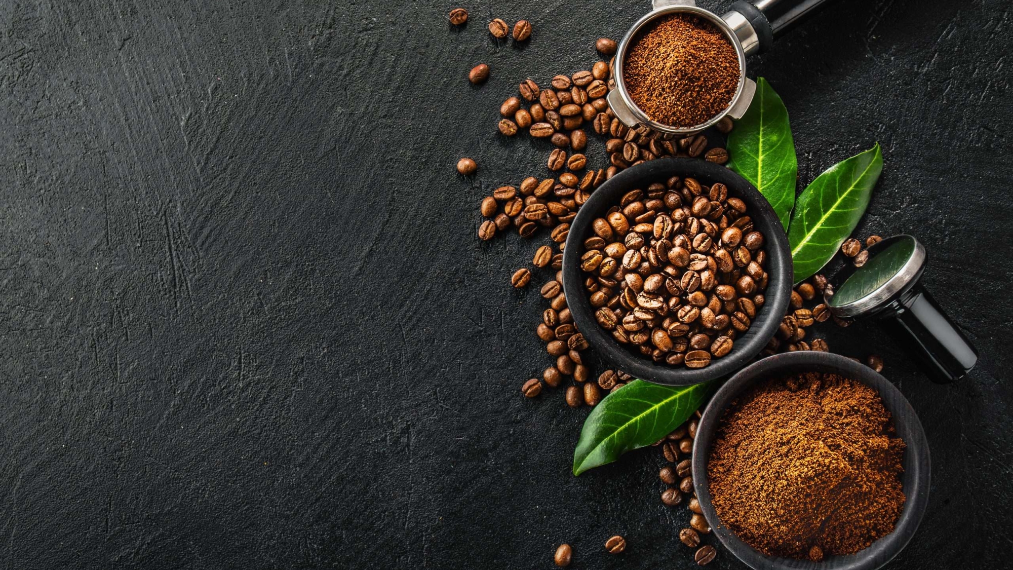 Coffee beans and coffee powder with tamper on dark background. Coffee concept. Coffee background. Flat Lay.