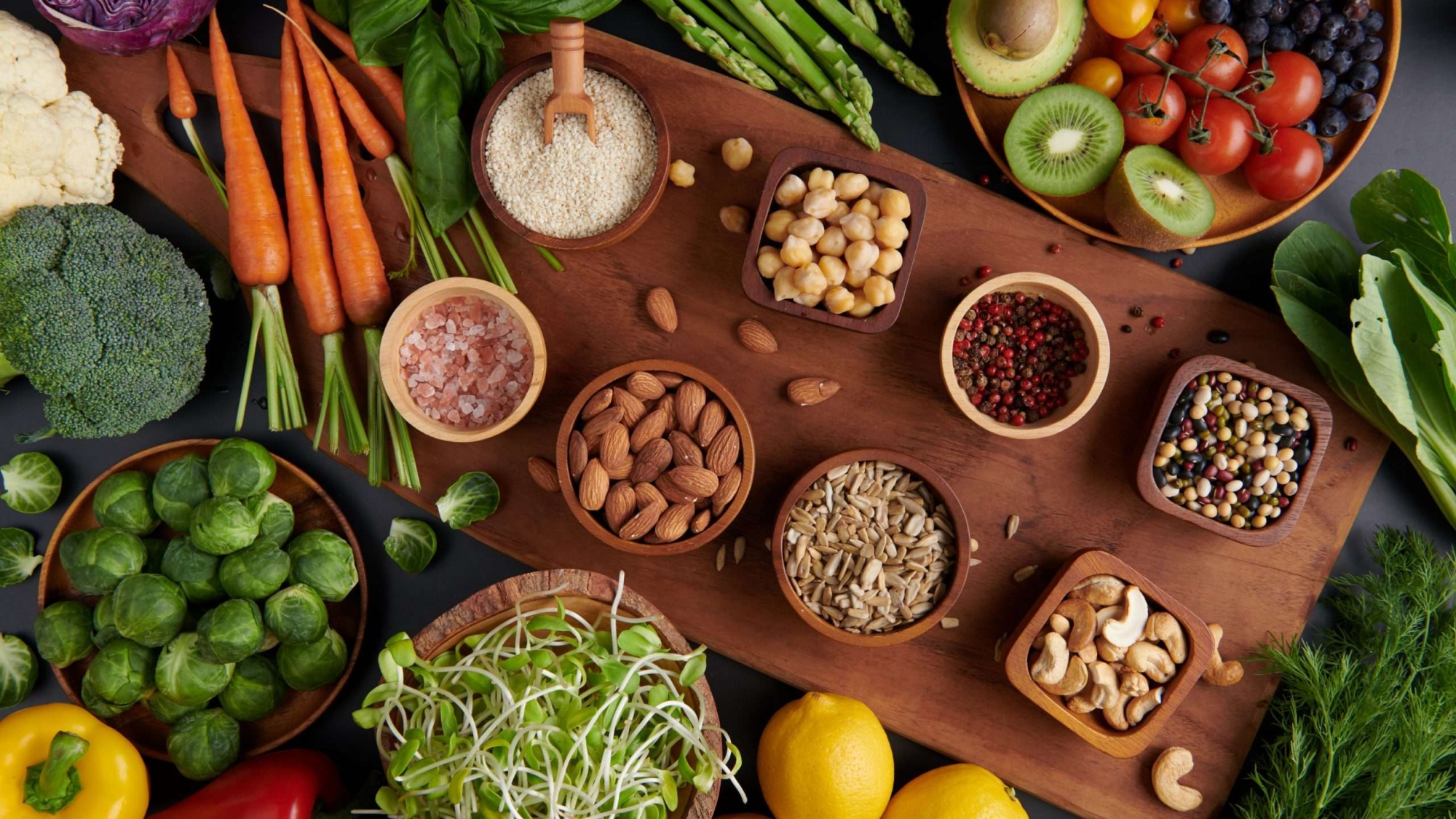 Different vegetables, seeds and fruits on table. Healthy diet.
vegetarian, vegan food cooking ingredients. Flat-lay of vegetables, fruit, beans, cereals, kitchen utencil, dried flowers, top view.