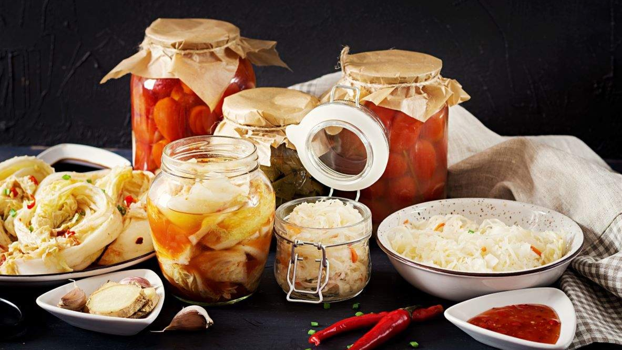cabbage-kimchi-tomatoes-marinated-sauerkraut-sour-glass-jars-rustic-kitchen-table (1)